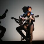 Woman on chair with a guitar doing not a lot of anything 4Fun