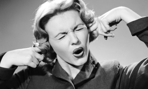 Woman with her fingers in her ears Fingers in ears