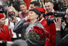 Austria to host 70th Eurovision Song Contest Photo: The Canadian Press JJ, center, from Austria arrives at the airport in Vienna, Austria, Sunday, May 18, 2025, after winning the Grand Final of the 69th Eurovision Song Contest, in Basel yesterday.